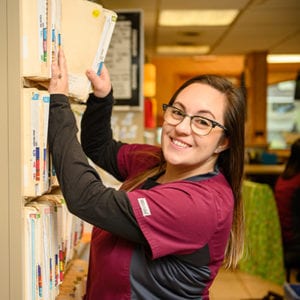 Veterinarian Putting a File Away